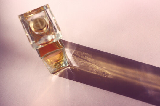 Top view image of perfume bottle on pink pastel background