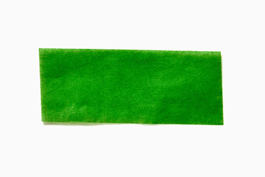 Green confetti paper on white background