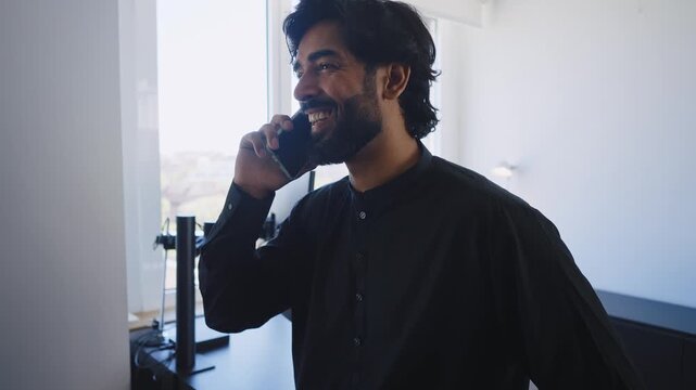 Pakistani Business man in the office. Corporate scene in a modern office with a businessman from pakistan in traditional jubba kandora.