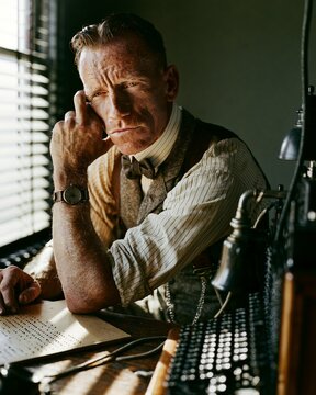 1900s telegraph operator leaning back from a blank wooden Morse code desk with clean