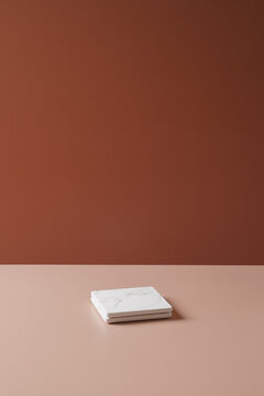 Minimalist brown background with a warm terracotta wall and beige surface, creating a clean and elegant backdrop for product photography.