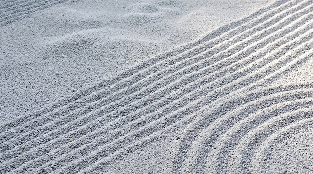 Raked white sand pattern in a Japanese zen rock garden