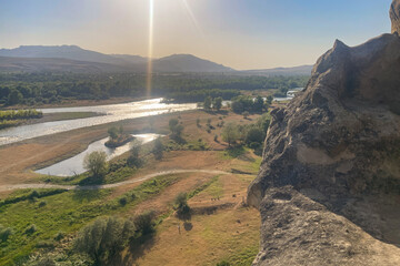 Mountain cliff and view of Kura river and summer Georgian hill © millaf (Nemchinova)