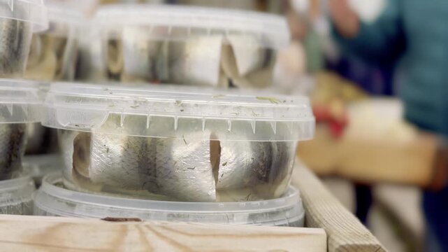 Close View of Glass Jars of Marinated Herring at a Market