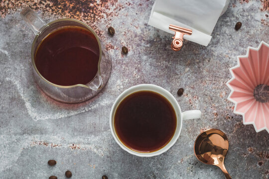 Filter coffee in cup and glass pot with origami coffee filter