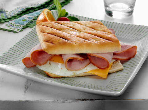 Panini sandwich with Ham, fried egg, and American cheese breakfast
