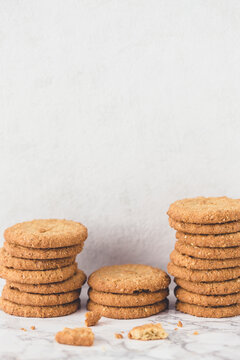 Stacks of oatmeal cookies on a marble surface