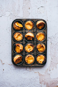 Rooibos Tea, custard tarts baked in muffin tin on baking tray
