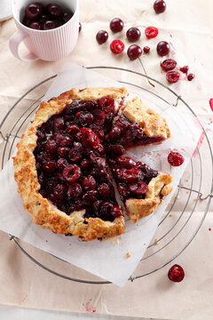 Rustic Cherry galette with fresh and pitted cherries on cooling rack