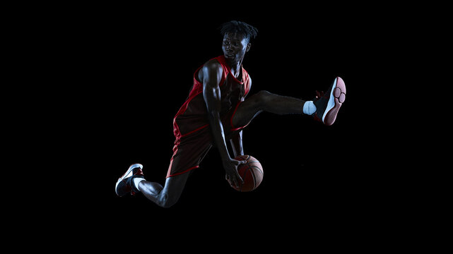 Young male basketball athlete jumping with ball beneath extended leg on black studio background with focused gaze. Freestyle competitions, sneaker retail concept.