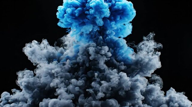 Vibrant blue pigment swirls into dark grey smoke clouds against black background