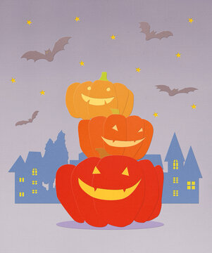 Three Stacked Halloween Pumpkins at Night