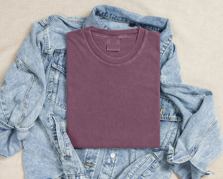 Blank washed red folded shirt mockup over blue denim jacket, crewneck template for print on demand