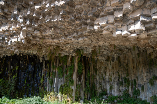 Basalt Rock Overhang and Green Vegetation at the Symphony of Stones, Garni, Armenia.