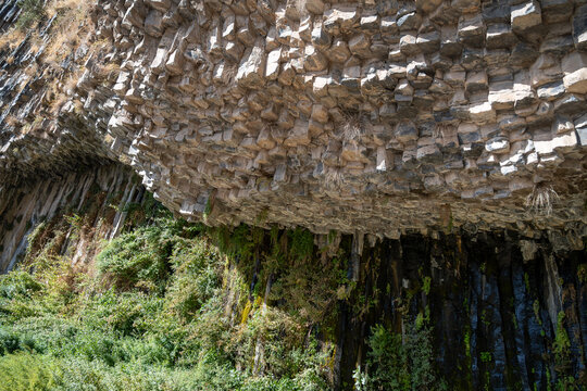 Basalt Rock Overhang and Green Vegetation at the Symphony of Stones, Garni, Armenia.