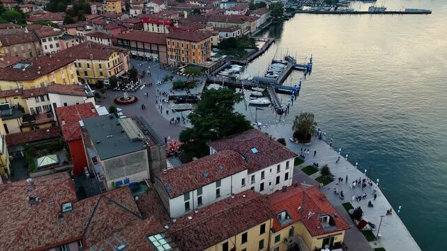 Aerial drone view of Iseo town rooftops and marina, Lake Iseo, Italy