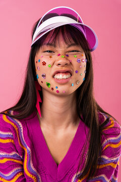 Beautiful asian woman portrait, asian woman making playful grimace with face gems