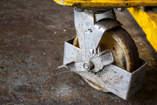 Close up view of swivel caster wheel with locking brake on heavy equipment dolly