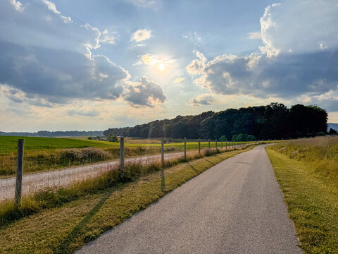 Sun shining over empty country road