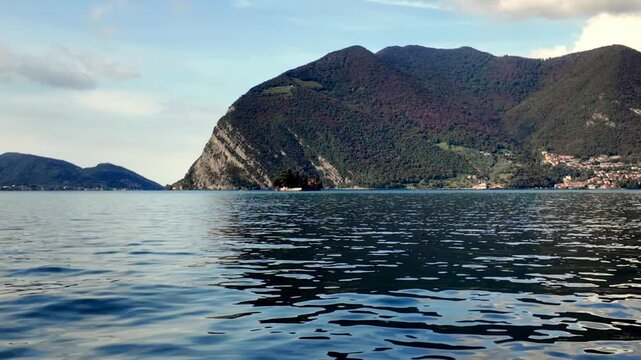 Lake Iseo with Isola di Loreto and forested mountains, Lombardy, Italy