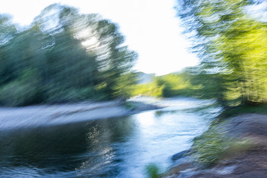 Calm river and trees, blurred motion