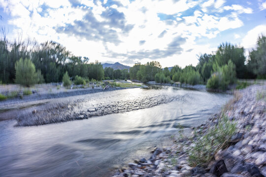 Calm river and trees, blurred motion
