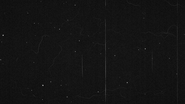 Old film overlay with flickering dust and scratches on black and a sudden film burn flash