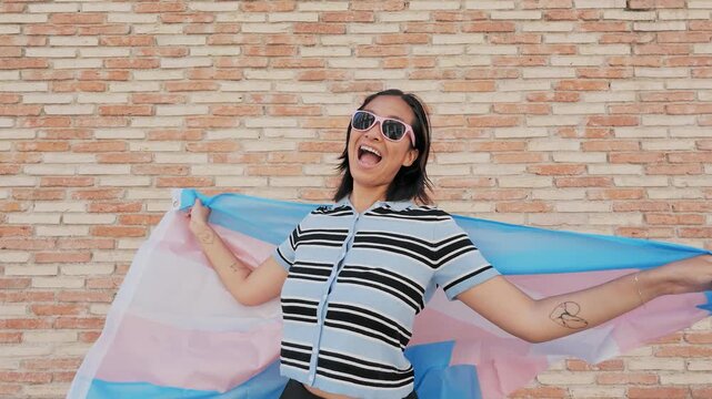 Joyful person waving transgender pride flag