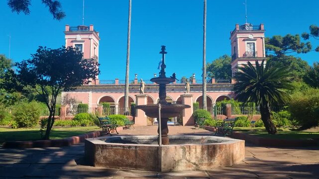 Historic Palacio San Jos&eacute; in Entre R&iacute;os, Argentina, bathed in bright sunlight, with elegant 19th century architecture, lush gardens and landscaped grounds surrounding this iconic heritage site