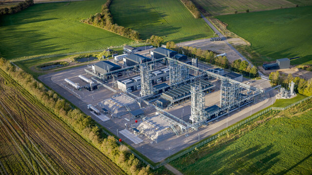 Aerial view of industrial power-to-X facility for green e-methanol production. State-of-the-art power-to-X plant for producing green hydrogen and sustainable e-methanol from renewable energy sources.