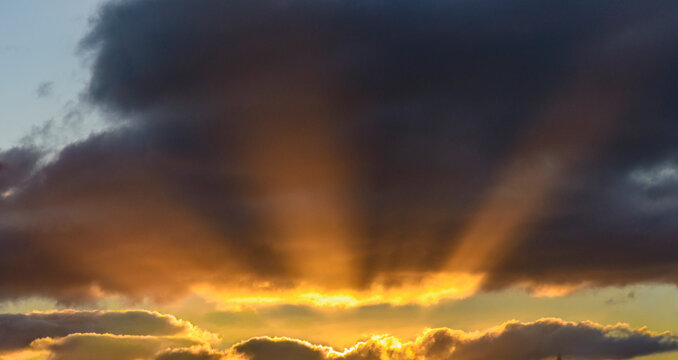 Sunbeams break out from sunset cloud formation
