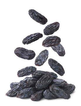 Raisins falling on a pile close-up on a white. Isolated