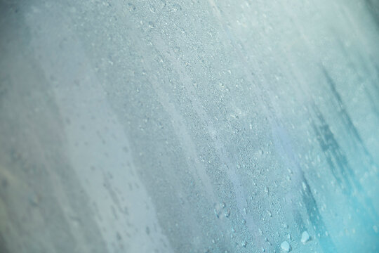 Diagonal macro shot of dense water droplets and condensation on a glass surface.
A high-quality