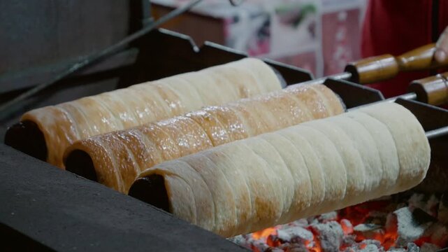 Enjoy watching the preparation of cozonac and curd cake at a lively Christmas market. The flavors and aromas fill the air during this festive time.