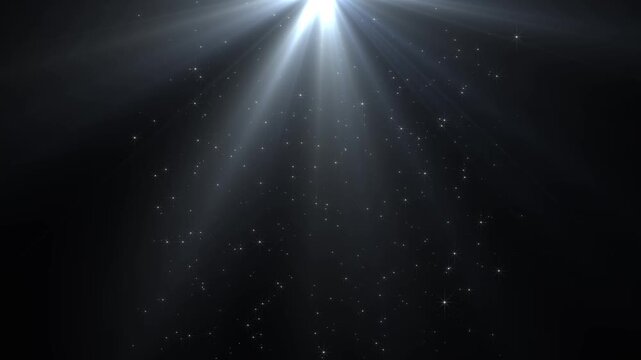 Slow motion of dust particles falling mid air over dark background with glowing godray in 4k resolution