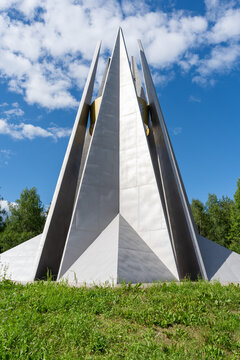 Tall memorial pylons above a grassy slope in Ukhta, Komi Republic