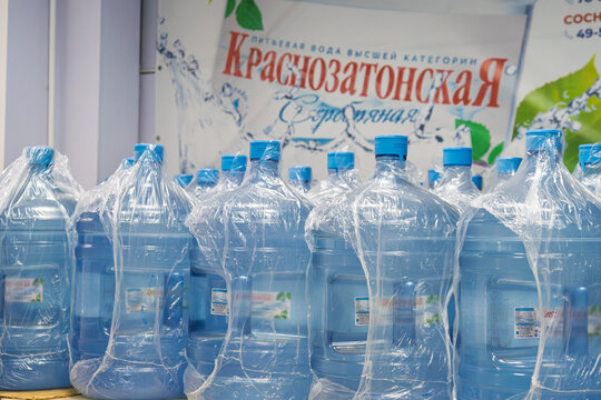 Large Krasnozatonskaya drinking water bottles at local water order point in Ukhta, Komi Republic, Russia