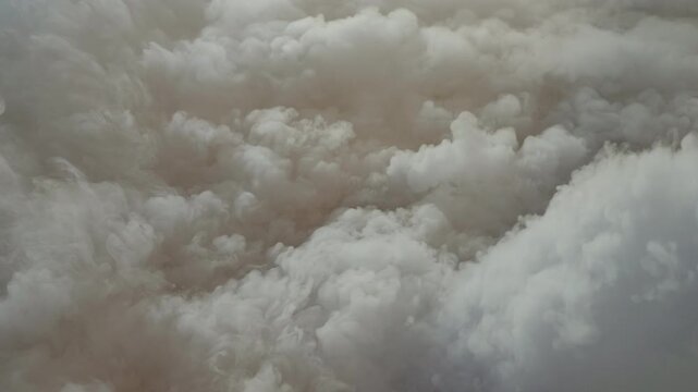 Dense, turbulent clouds of dark gray and brown smoke billowing upwards after a massive explosion, creating a dynamic and chaotic background of pollution, fire aftermath, and disaster