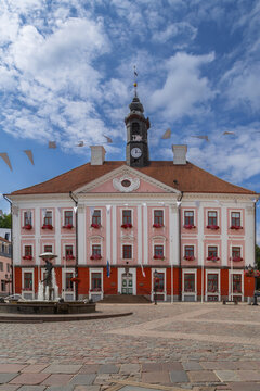 Front facade of Town Hall in Tartu, Estonia. Daytime view with light clouds over classicist architecture