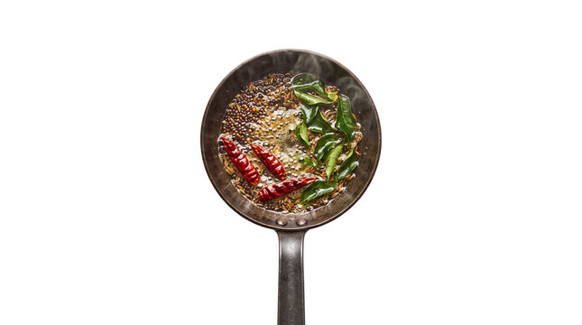 Sizzling Indian tadka tempering with red chilies and curry leaves, aromatic spice seasoning in a rustic pan, culinary preparation for traditional food isolated PNG with Transparent Background
