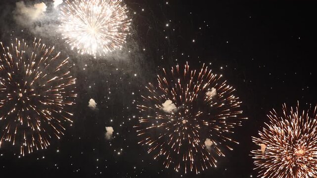 Bright fireworks burst dynamically across a dark night sky with smoky textures, creating a festive display for New Year celebrations, Independence Day events, holiday parties, and grand festivals