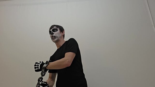 homem esqueleto  preso a correntes 