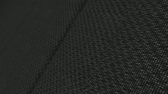 Detailed Cinematic Movement Along Italian Charcoal Grey Birdseye Wool Fabric with Angled Camera View, Soft Lighting and Intricate Woven Surface Details