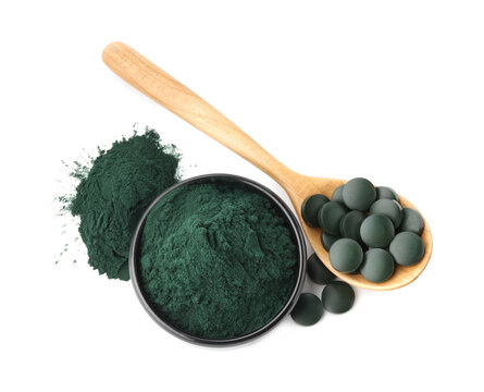 Green spirulina tablets and powder isolated on white, top view