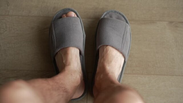 soft slippers on a man's feet.
House slippers