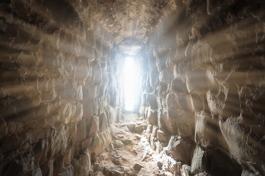 sunlight shining into the empty tomb of jesus, easter background with copy space, religious symbolism for resurrection and salvation