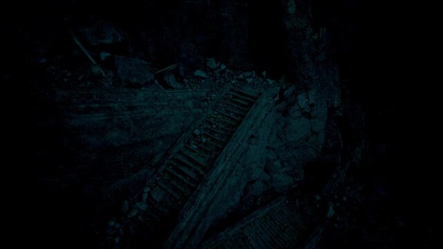 Deep within a dark cavern, an ancient and worn wooden staircase is barely visible among the scattered stones and debris. Mysterious shadows cast an eerie glow in this haunting atmosphere.