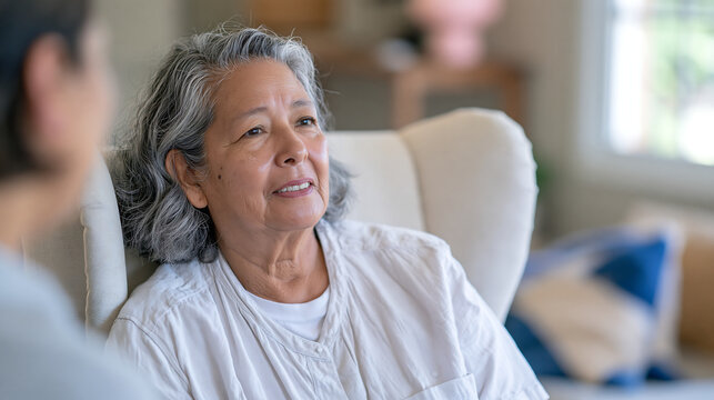senior woman in a floral blouse holding a paper document while talking with a financial advisor in a bright office showing retirement planning and insurance consultation