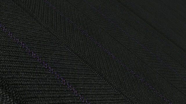 Bold Cinematic Movement Along Italian Charcoal Herringbone Pinstripe Wool Fabric with Angled Perspective, Dramatic Lighting and Intricate Woven Patterns