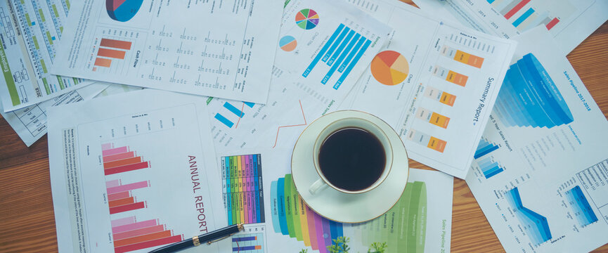 Banner Excel graph with Spreadsheet Document showing Information Financial Startup Concept. Banner Office laptop business financial document chart and graph on office wooden table coffee cup.